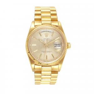 Rolex day-date President 18K gold men’s wristwatch, having a champagne tapestry dial with baton numerals and a leather-wrapped presentation box. Estimate: $12,000-$18,000