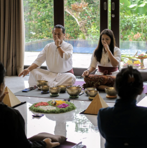 People sitting and performing rituals at a JUARA bali wellness retreat