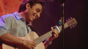 Anuv Jain performs live on stage in Dallas, TX during the North American leg of Dastakhat World Tour 2026, playing acoustic guitar in front of a sold out crowd. Photo by Anlesh Dangol for Kash Patel Productions.