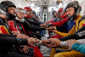 Skydivers inside the airplane getting ready to jump