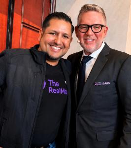 Robert Gomez, founder of ReelMap, standing with real estate coach Tom Ferry at a real estate industry event.