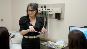 Erin Sing, DNP, CNM, director of the Nurse-Midwifery Master’s Degree Program in the TTUHSC School of Nursing, instructs two students in a clinical setting.