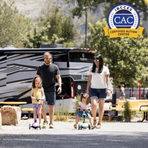 Parents walk behind their two young children who are biking at Billings KOA Holiday campground.