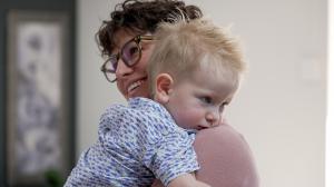 Leticia Trowbridge smiles while holding her two-year-old son, who was delivered via a nurse-midwife-assisted water birth at home.