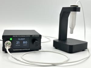 Croxel HTS Heated Tip Syringe System powered on, with controller display active and handpiece resting in the smart holder.