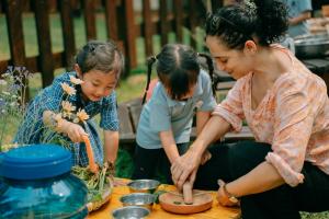 Pupils at The Independent School of Jakarta (ISJ) during an outdoor "garden school" lesson with their teacher at the school's Pondok Indah campus in South Jakarta.