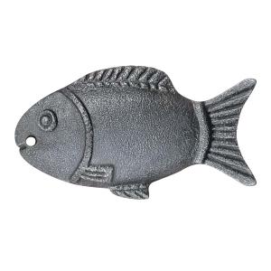 Fish-shaped cast iron cooking tool used during boiling and cooking applications in kitchen preparation workflows.