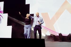 Experior Co-Founders Lee-Ann and Jamie Prickett on stage Experior Factor 2026 cheering and smiling