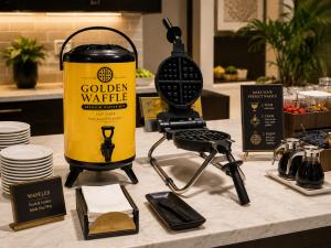 Golden Waffle sleek batter dispenser helping hospitality operators improve waffle service presentation, reduce mess and create a premium self-service experience.
