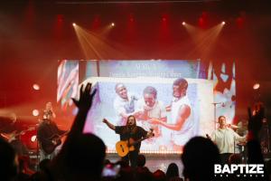 Leeland leads worship at the Museum of the Bible in Washington, D.C., during Baptize the World as livestream footage from Uganda’s Kawempe Worship Center in Africa shows baptisms taking place as part of the global Pentecost Sunday event.