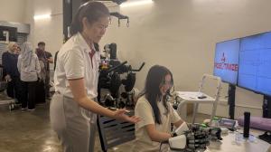 Demonstration of HandVivante MirrorHand to a UM student.