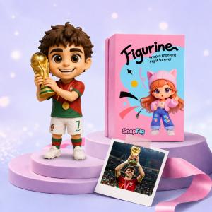 Custom 3D football figurine wearing a red and green national team kit and holding a gold championship trophy, next to a pink SnapFig gift box.