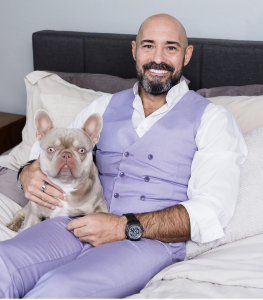 Thomas, the Lavender Matchmaker and LLMA founder, with his French Bulldog Dior at home in Gilbert, AZ