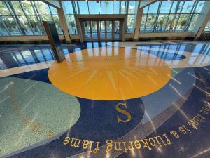 Sun design in terrazzo at entryway with lettering
