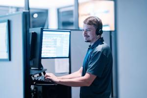 Cybersecurity professional monitoring business systems and security alerts to help protect organizations from cyber threats.