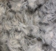 The Micro-Reinforcement Revolution: A close-up view of raw ExCfiber™ filaments. Added directly to the mix, these sustainable carbon fibers create millions of tiny bridges, locking concrete together at the microscopic level.