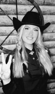 Bee Smith Holding Up A Peace Sign