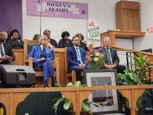Rev. Al Sharpton pictured with Rev. Bolívar Flores and Rev. Raul Ruiz seated during a faith and community event