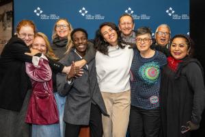 Global Pluralism Award 2025 laureates smiling in front of a navy blue background with the Global Centre for Pluralism logo