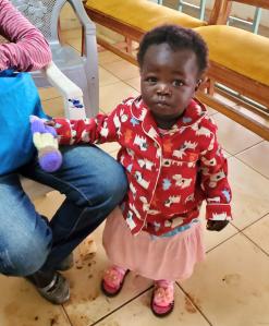Young child in Kenya with Izzy Doll