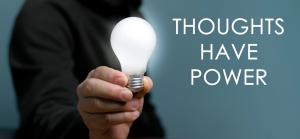 photo of the arm of a man holding a lite light bulb with the words in large letters "thoughts have power"