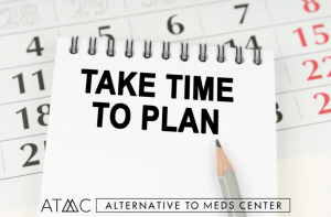 Notebook with text take time to plan and pencil on calendar background representing importance of careful planning for safe medication tapering