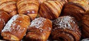 Photo shows multiple baked items including croissants, viennoiseries and pain au chocolat.