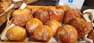 A variety of vennoisieries are shown in a basket. The pastries are a French tradition.