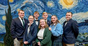 Geneva Academy upper-school students pose in front of a Starry Night artwork display at the classical Christian private school in Roseburg, Oregon