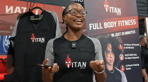 Woman trying on TitanBody EMS fitness suit.