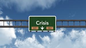 photo of a large road sign with the words Crisis, Exit here