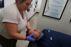 Dr. Alexandra Zoda performing cranial adjustment at Absolute Chiropractic Sea Girt NJ