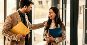 Two smiling professionals in a coworking soace