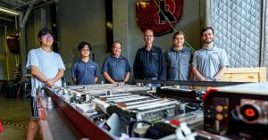 Rose-Hulman students and faculty stand near the battery the students designed as part of the Battery Workforce Challenge.