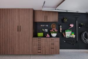 Custom walnut garage cabinets, black slatwall storage, and flake-finish flooring by Precision Closets & Garage in American Fork, Utah