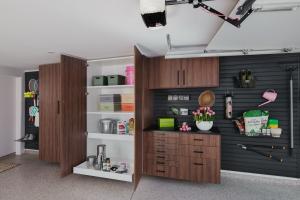 Open custom garage cabinets with adjustable pull-out shelving and slatwall organization by Precision Closets & Garage, Utah
