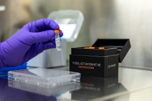 Image of a scientist using reagents from a kit with a 96-well plate