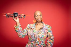 Steffanie Rivers holding a drone while promoting drone certification and public safety training through TCB Drones Academy in Texas.