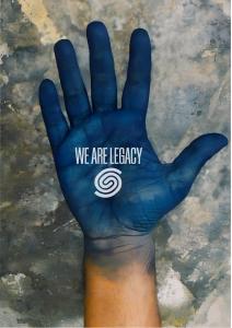 Blue-painted human hand with the We Are Legacy logo displayed on the palm, symbolising the people and craftsmanship behind handmade products.