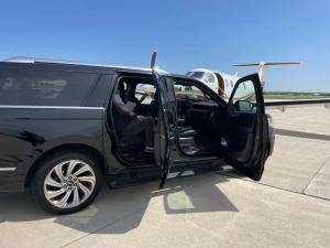 Passengers Sitting in Chevy Suburban at FBO