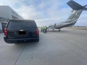 Black Luxury Chevrolet Suburban at FBO with Staff