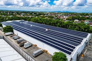 Aerial view of Oishi’s Imus, Cavite facility with a large rooftop solar panel installation by Solaren Renewable Energy Solutions Corp.
