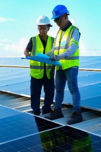 Solaren Renewable Energy Solutions Corp. engineers inspecting solar monitoring equipment, electrical meters, and premium commercial solar components at a project site in the Philippines.
