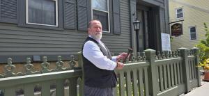 Larry Ioverde, who plays Andrew Borden at the Lizzie Borden House, holds an 1880s gate rod that was discovered recently during restoration of the fence at the House. The gate rod is believed to be the original ironwork installed by Andrew Borden more than
