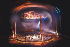 Various performers dance on a circular stage at Terhal.