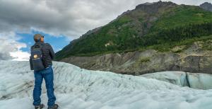 Off the Beaten Path group traveler taking in sweeping views of Root Glacier in Alaska.