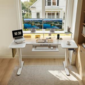 OffiGo 55-inch white U-shaped electric standing desk in a bright home office with dual monitors, laptop stand, keyboard tray, and organized desktop accessories.