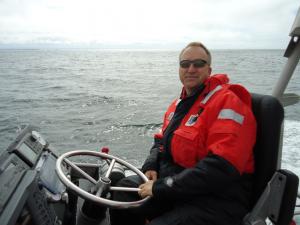 Mike Colbach in a flotation suit driving a Coast Guard 47' Motor Life Boat for a day training with a Coast Guard crew from Cape Disappointment.