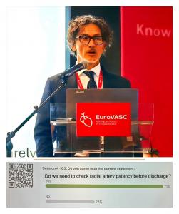 Dr. Giovanni Amoroso, Medical Director and Co-Founder of IDAHealth Inc., delivering the split lecture “Maintaining is enough?” at EuroVASC 2026. During the session, 72 percent of participants agreed that radial artery patency should be routinely assessed 