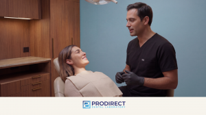 Dentist speaking with a smiling patient in a dental chair, representing PRODIRECT Dental Laboratory’s Omni Connect scanner ownership program for dental practices.